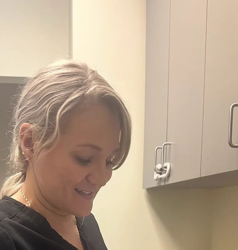Yuliya Rashevska preparing an injection in a clinic exam room