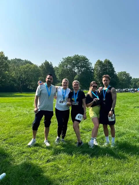 Pure Wellness Clinic team with medals after the 5k run for Ukraine